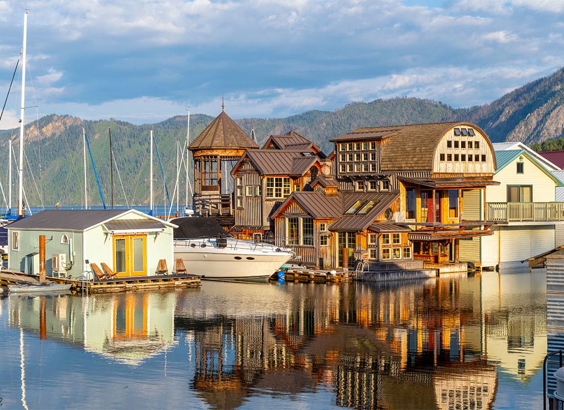 Coeur d’Alene, ID - Buildings on Stilts on the Lake with Mountains in the Distance in Coeur d’Alene Idaho