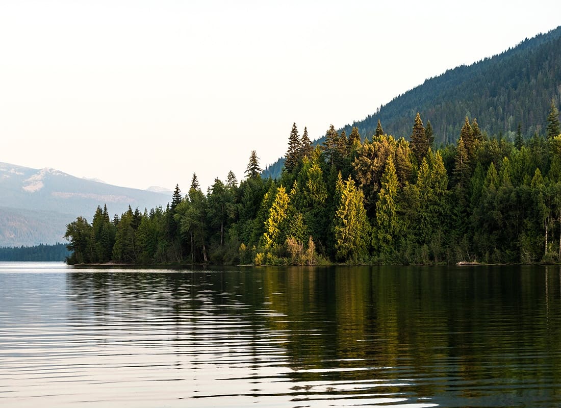 Service Center - Lake Surrounded by Pine Trees and Mountains on a Sunny Day in Northern Idaho